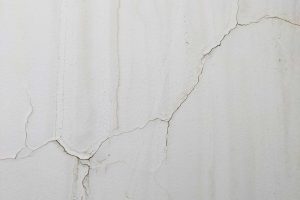 A close-up image of a cracked drywall panel needing professional repair